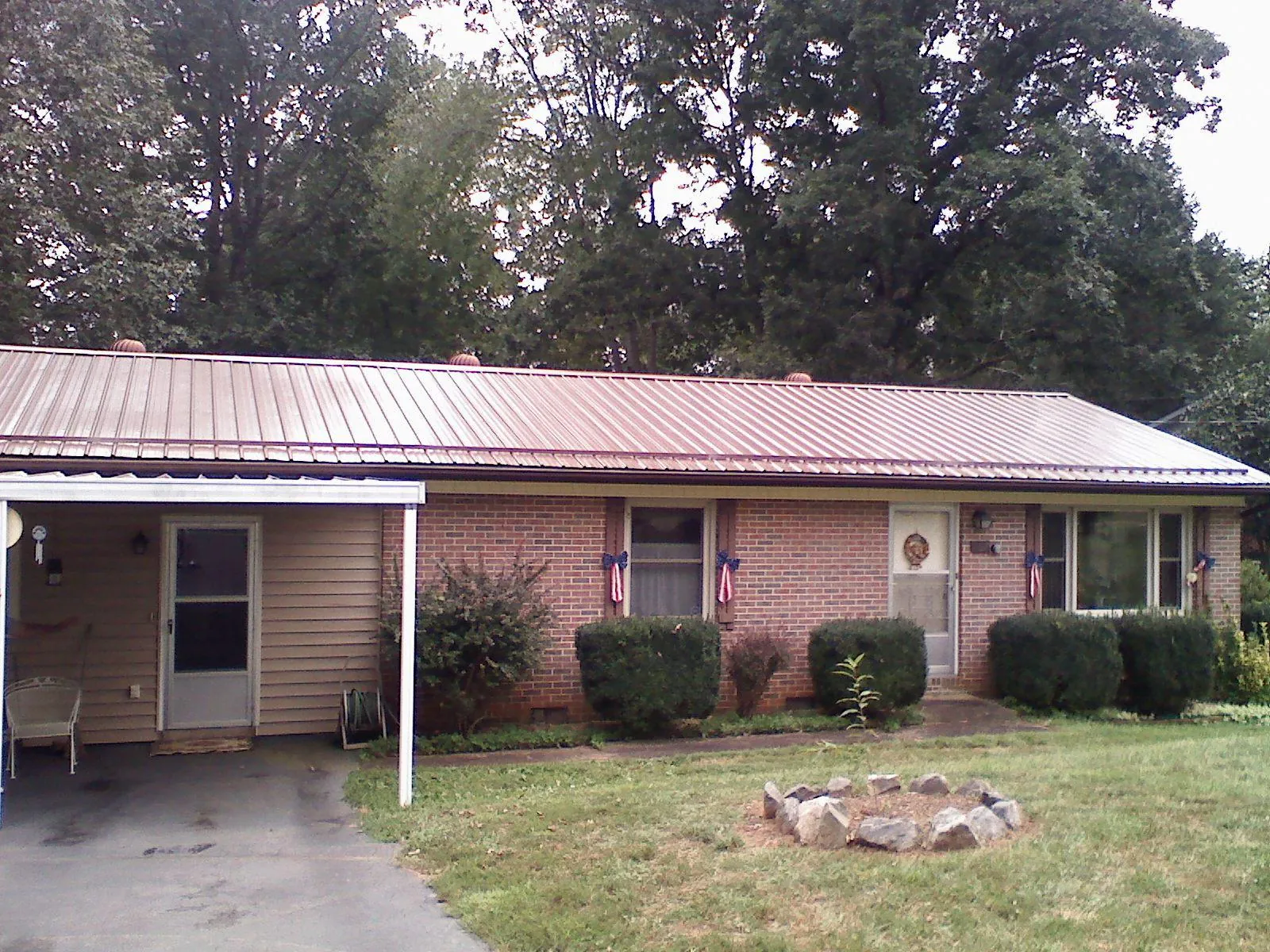 Bronze metal roof and carport on a brick ranch home — Roof Repair work by our crew in Payson