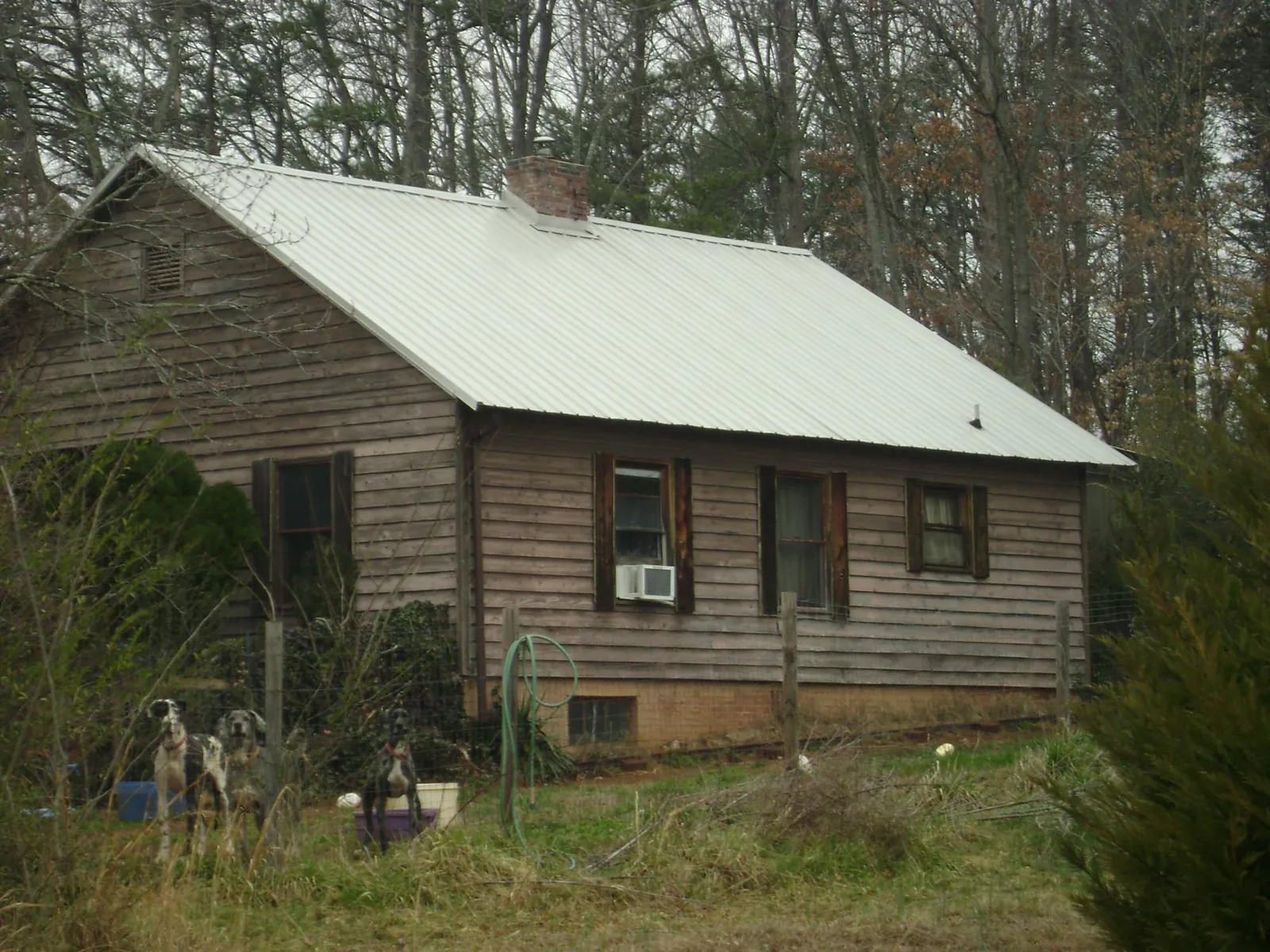 White metal roof on an old wood sided farmhouse, from a Metal Roof Installation job in Payson